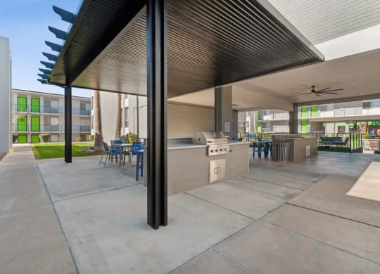 Covered outdoor kitchen space with BBQ grills