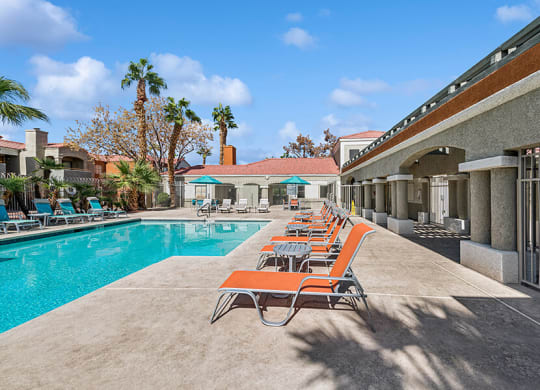 Community Swimming Pool with Pool Furniture at Stonegate Apartments located in Las Vegas, NV.