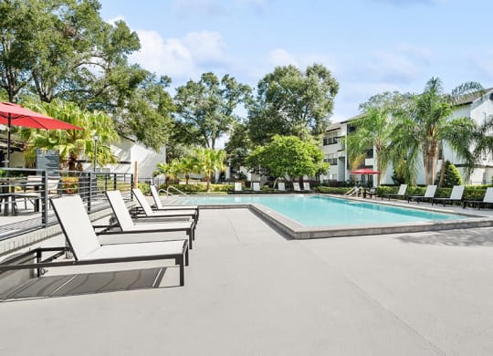 Community Swimming Pool with Pool Furniture at Rosehill Preserve Apartments in Orlando, FL.