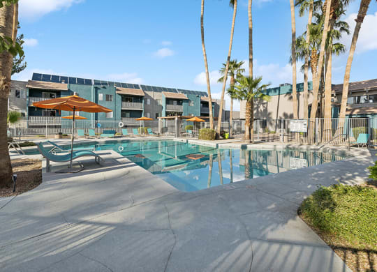 Community Swimming Pool with Pool Furniture at Tanque Verde Apartments located in Tucson, AZ.