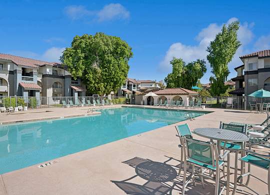 Community Swimming Pool with Pool Furniture at Stillwater Apartments located in Glendale, AZ.