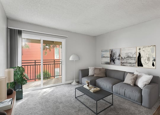 Model Living Room with Carpet and Patio Accessibility at The Archer Apartments in Sacramento, CA.