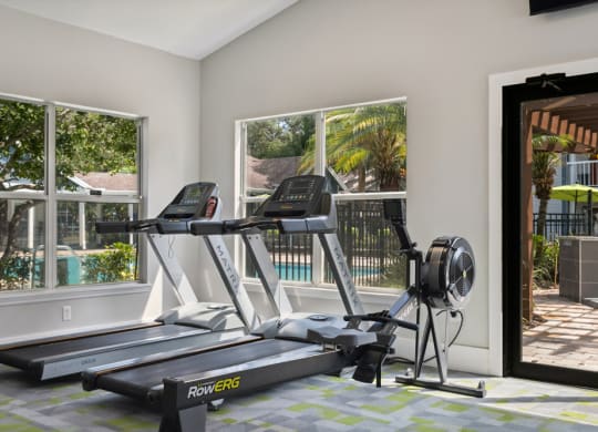Fitness center with treadmills at Retreat at Crosstown Apartments