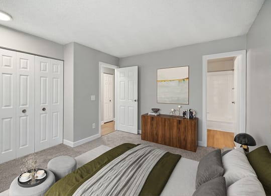 Model Bedroom with Carpet and attached Bathroom at Waterfront Apartments in Lakewood, CO.