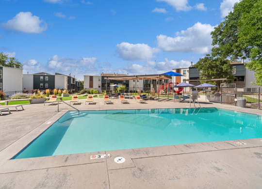 Community Swimming Pool with Pool Furniture at Waterfront Apartments in Lakewood, CO.