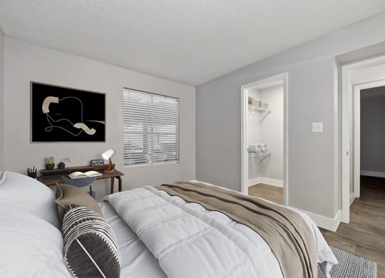 Model Bedroom with Wood-Style Flooring and Walk In Closet at Crystal Creek Apartments located in Phoenix, AZ.