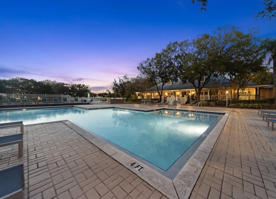 Community Swimming Pool with Pool Furniture at Walden Lake Apartments in Plant City, FL.