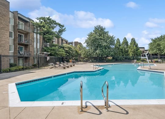 Community Swimming Pool with Pool Furniture at Mason Van Dorn Apartments located in Alexandria, VA.