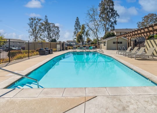 Community Pool & Pool Furniture at Forest Park Apartments in El Cajon, CA.