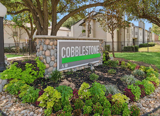 Monument Sign and Landscape at Cobblestone Apartments located in Arlington, TX.