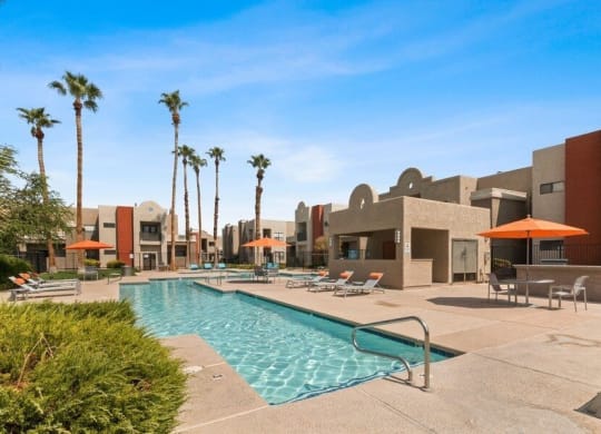 Swimming pool and lounge chairs with cabanas