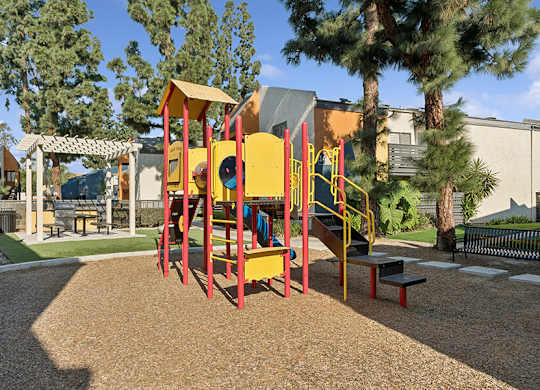 Community Playground with Slide at Horizon Apartments located in Santa Ana, CA.