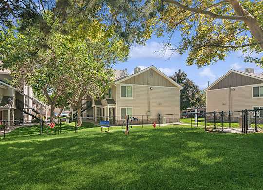 Community Dog Park with Agility Equipment at Broadmoor Village Apartments located in West Jordan, UT.