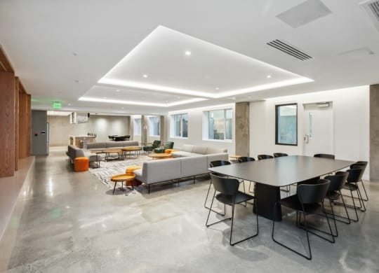 Community lounge with sofas and tables at TL Residences