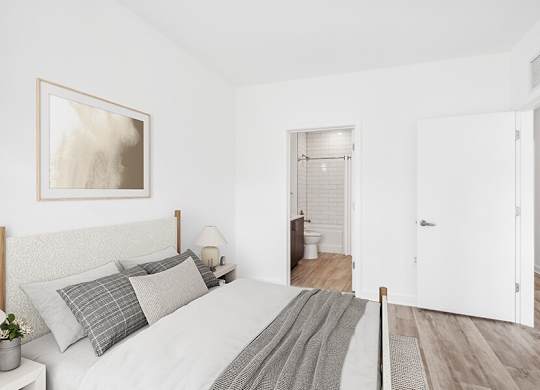 Model Bedroom with Wood-Style Flooring and attached Bathroom at Stella Apartments located in New Carrollton, MD.