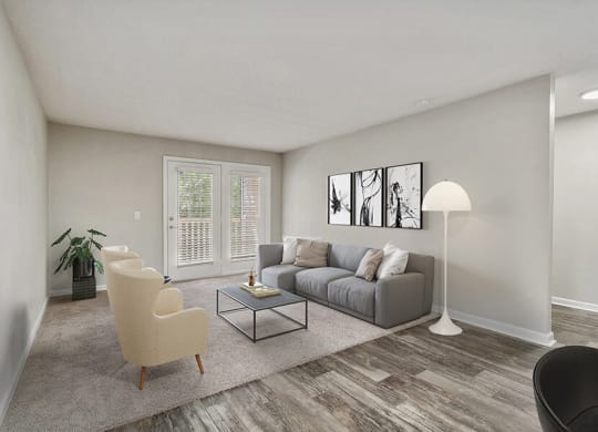 Model Living Room with Carpet and Patio Accessibility at Retreat at Stonecrest Apartments located in Lithonia, GA.