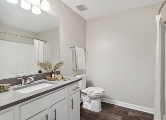 Model bedroom with white vanity at Retreat at Stonecrest Apartments