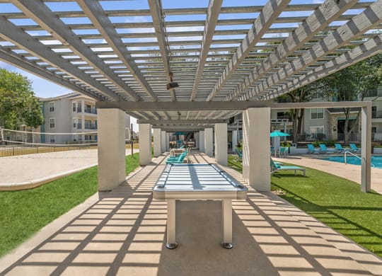 Outdoor Ping Pong Table and Pool Area at Essence Apartments in Dallas, TX.