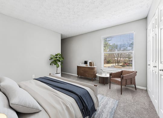 Model Bedroom with Carpet and Window View at Paramont Apartments in Duluth, GA.