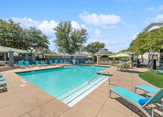 Community Swimming Pool with Pool Furniture at Allure North Dallas Apartments in Dallas, TX.