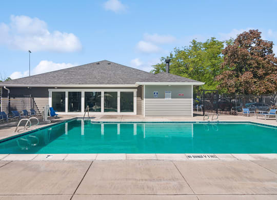 Community Swimming Pool with Pool Furniture at Overlook Apartments located in Salt Lake City, UT.