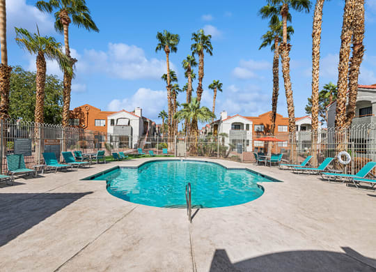 Community Swimming Pool with Pool Furniture at Stonegate Apartments located in Las Vegas, NV.