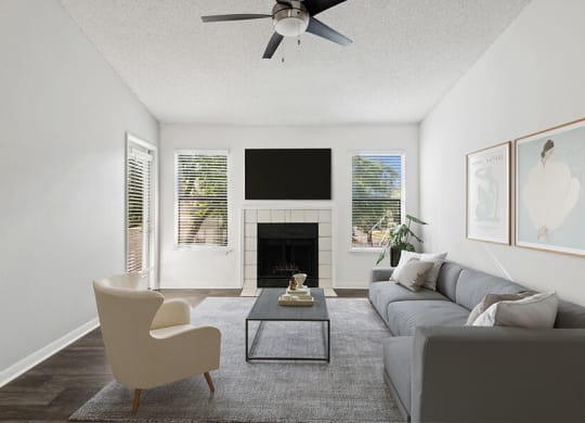 Model Living Room with Wood-Style Flooring, Fireplace & Patio Accessibility at Rosehill Preserve Apartments located in Orlando, FL.