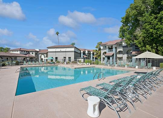 Community Swimming Pool with Pool Furniture at Stillwater Apartments located in Glendale, AZ.