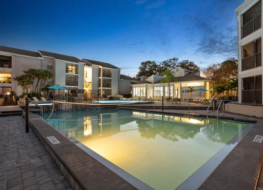 Community Swimming Pool with Pool Furniture at Haven at Water's Edge Apartments in Tampa, FL.