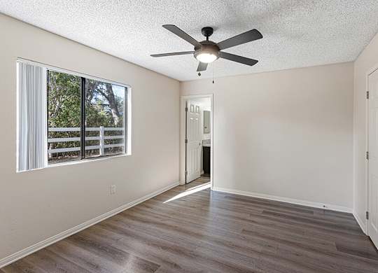 Model Bedroom with Wood-Style Flooring at Santa Fe Ranch Apartments located in Carlsbad, CA.