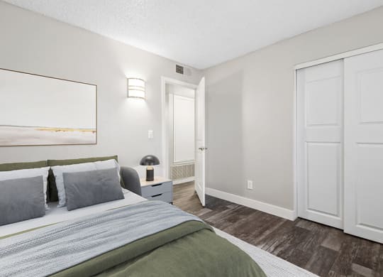 Model Bedroom with Wood-Style Flooring and Closet at Peaks on 4th Apartments in Avondale, AZ.
