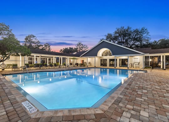 Community Swimming Pool with Pool Furniture at Retreat at Crosstown Apartments in Riverview, FL.