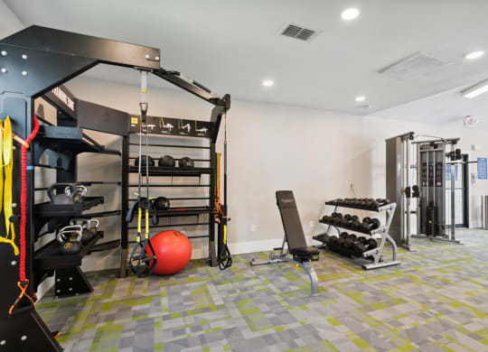 Fitness center with weights at Retreat at Crosstown Apartments