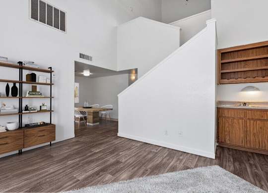 Model Living Room with Wood-Style Flooring at District at Fiesta Park Apartments located in Mesa, AZ.