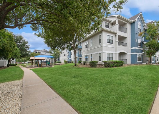 Exterior Community Building and Landscape at Hidden Creek Apartments located in Lewisville, TX.