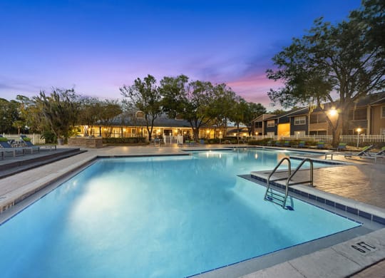 Community Swimming Pool with Pool Furniture at Walden Lake Apartments in Plant City, FL.