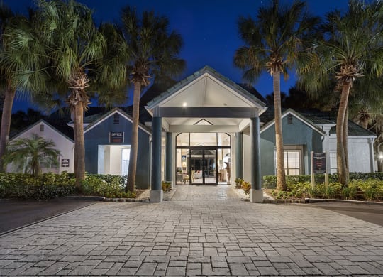 Exterior Community Building and Landscape at Caribbean Breeze Apartments in Tampa, FL.