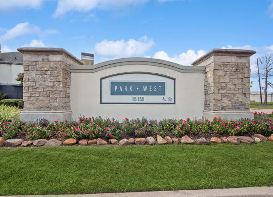 Monument Sign and Front Entrance at Park West Apartments located in Houston, TX.