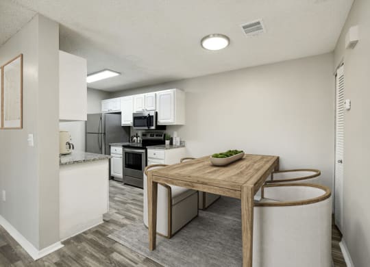 Model kitchen with a wooden table and two stools