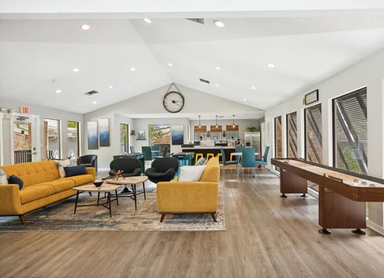 Community Clubhouse with Kitchenette, Lounge Furniture & Game Tables at Grand Pavilion Apartments in Tampa, FL.