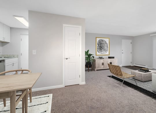 Model Living Room with Carpet and Patio Accessibility at Stone Ends Apartments in Stoughton, MA.