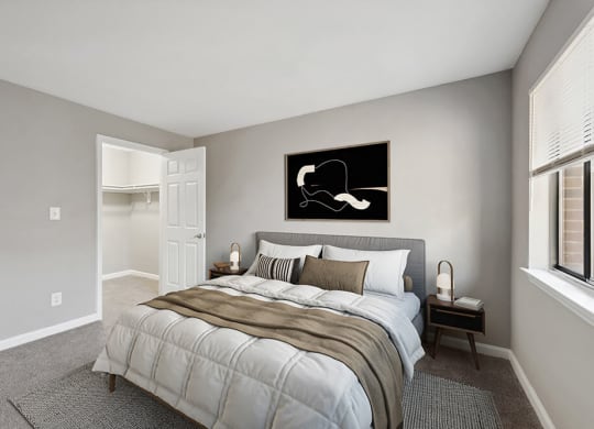 Model Bedroom with Carpet and Walk In Closet at Spring Forest Apartments in Raleigh, NC.