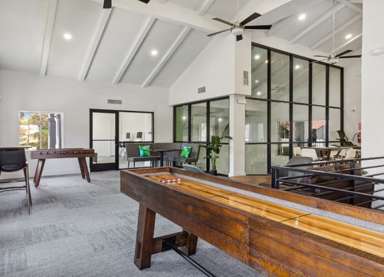 Community Clubhouse with Game Tables and Lounge Furniture at Meadow Ridge Apartments located in Las Vegas, NV.