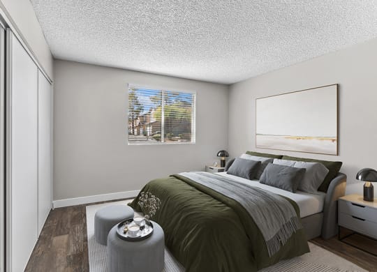 Model Bedroom with Wood-Style Flooring at Meadow Ridge Apartments in Las Vegas, NV.