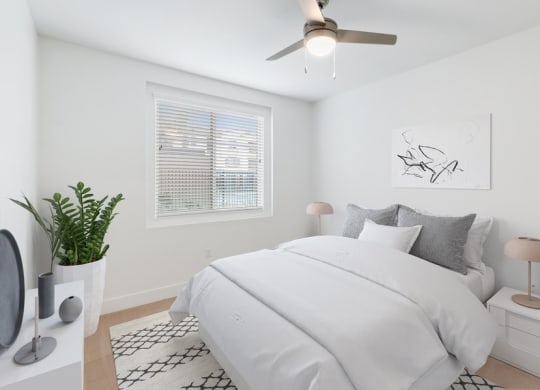 Model bedroom with queen bed and carpeting