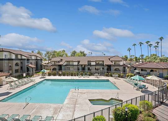 Community Swimming Pool with Pool Furniture at Stillwater Apartments located in Glendale, AZ.