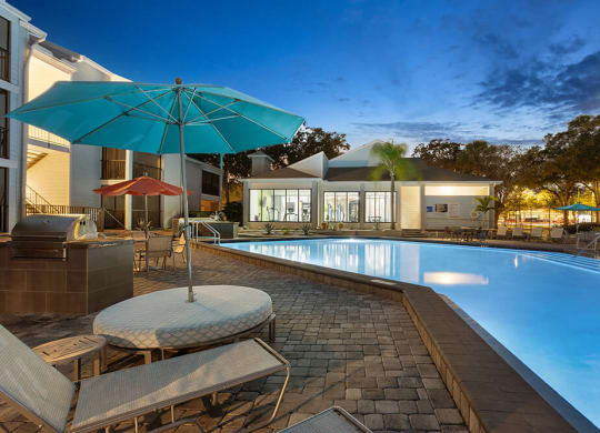 Community Swimming Pool with Pool Furniture at Haven at Water's Edge Apartments in Tampa, FL.