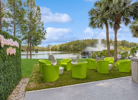 Outdoor lounge area with a fountain in the background and palm trees in the foreground