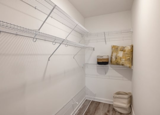 Model walk-in closet with white walls