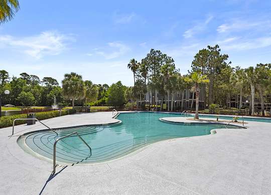 Community Swimming Pool with Pool Furniture at Mirage on Kernan Apartments located in Jacksonville, FL.